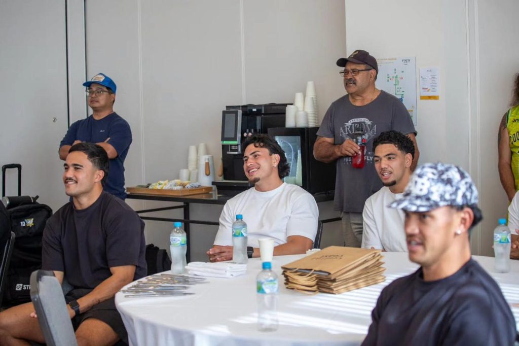 Aitu players and staff in a team meeting
