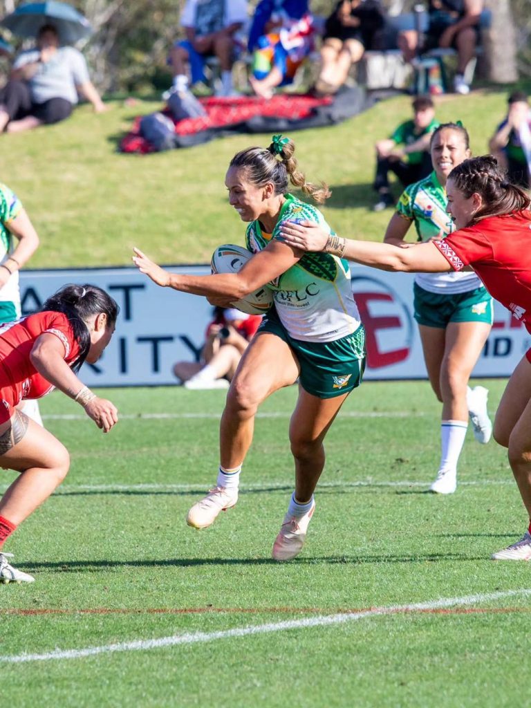 Moana player fends a Tonga defender